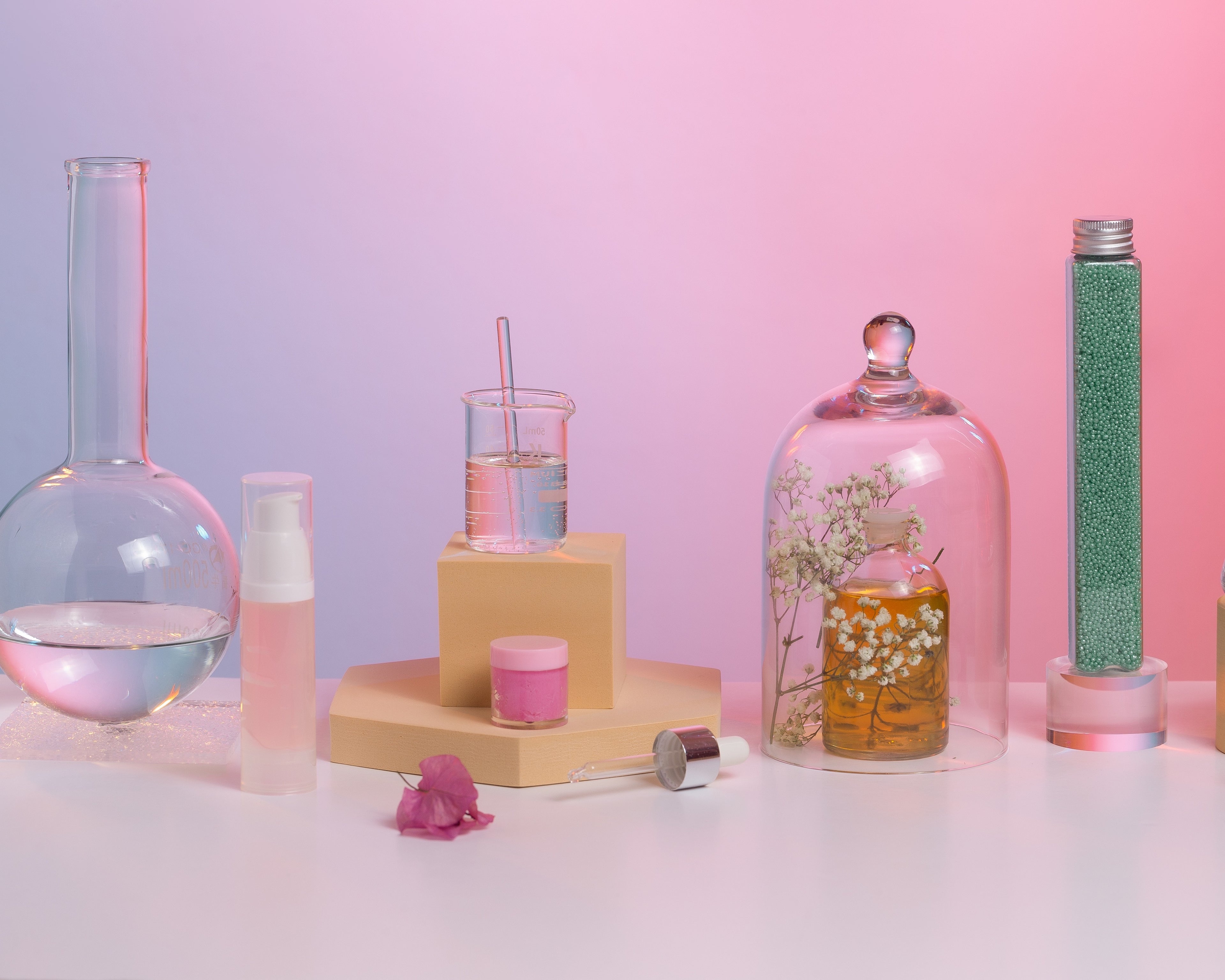 Science-themed decor with beakers, test tubes, and a pink background